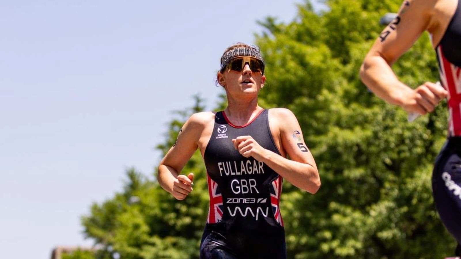 triathlete running at steady aerobic pace during Zone 2 training to improve endurance and race performance