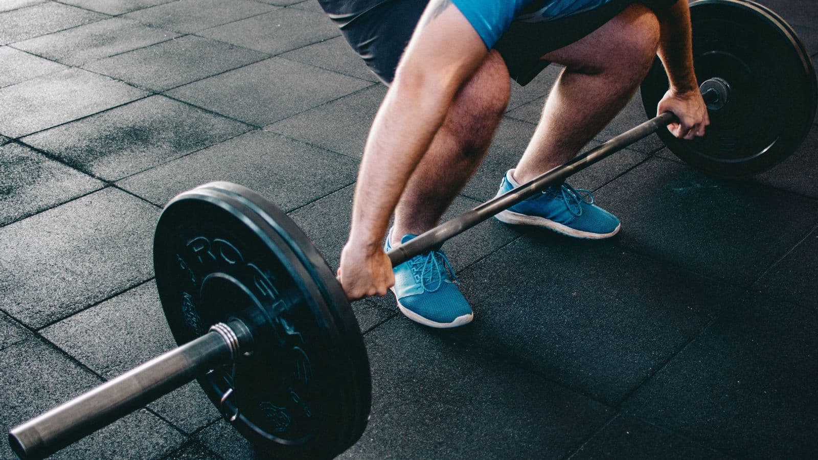Triathlete performing squats with dumbbells to build leg strength for injury prevention