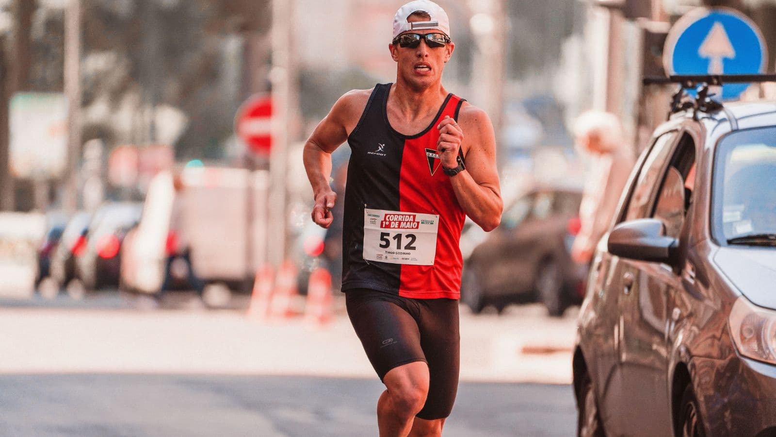 Triathlete running in hot and humid conditions with elevated heart rate during a low-intensity training session.