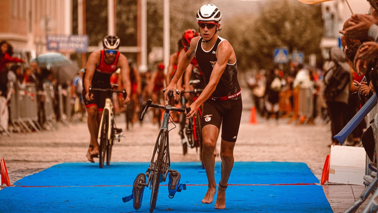 triathlete changing from swim to bike during T1 transition with efficient gear organization