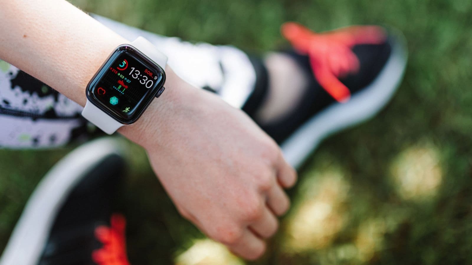 Triathlete checking heart rate on a GPS running watch after an easy run after noticing an unusually high heart rate.