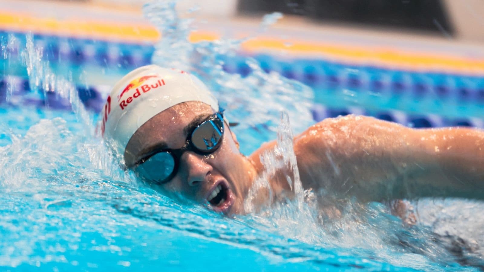 triathlete practicing freestyle swim pull technique in pool to improve propulsion and efficiency