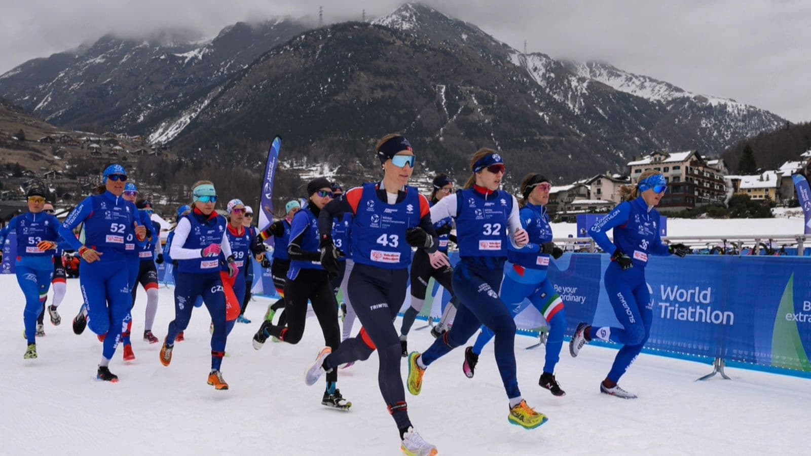 Triathlete performing dynamic warm-up exercises before a winter run to prepare muscles and reduce injury risk.