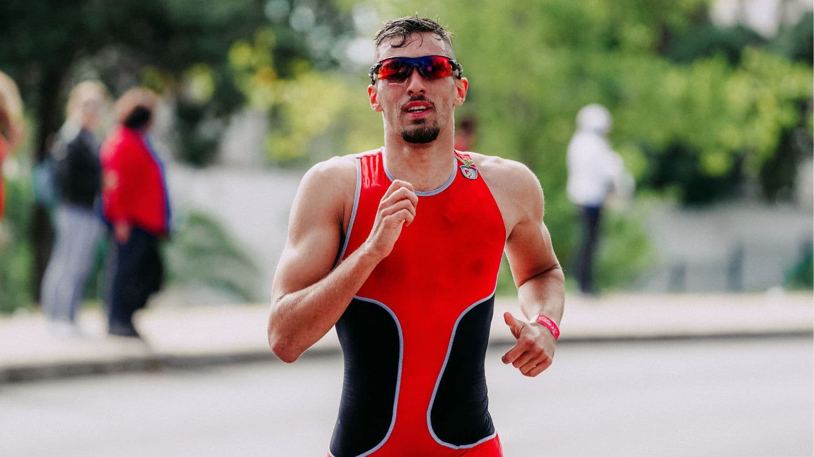 Triathlete increasing running pace during the final leg of a triathlon with efficient running form and endurance training.