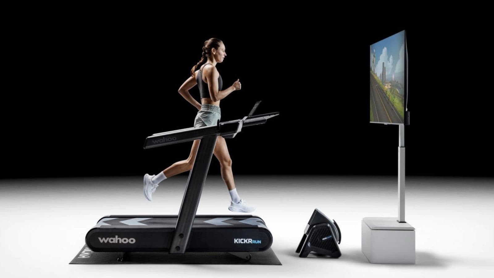 Triathlete running on a treadmill during a one-hour indoor training session to improve endurance and race fitness.