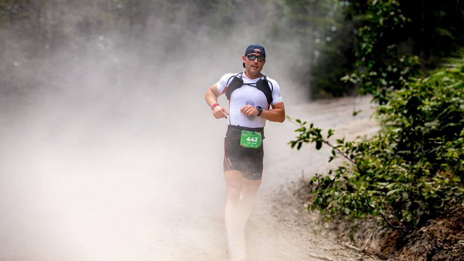 Triathlete running across rocky, uneven trail terrain to improve balance, coordination, and agility for triathlon performance.
