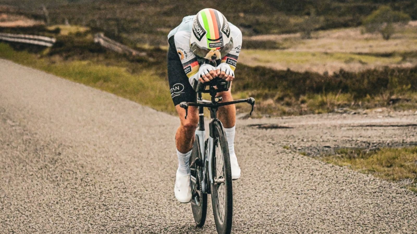 Cyclist riding in a low, aerodynamic position to reduce resistance during a headwind