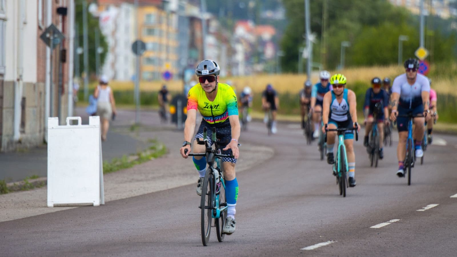 Triathlete riding a road bike during endurance training to build cycling speed and stamina for triathlon competition.