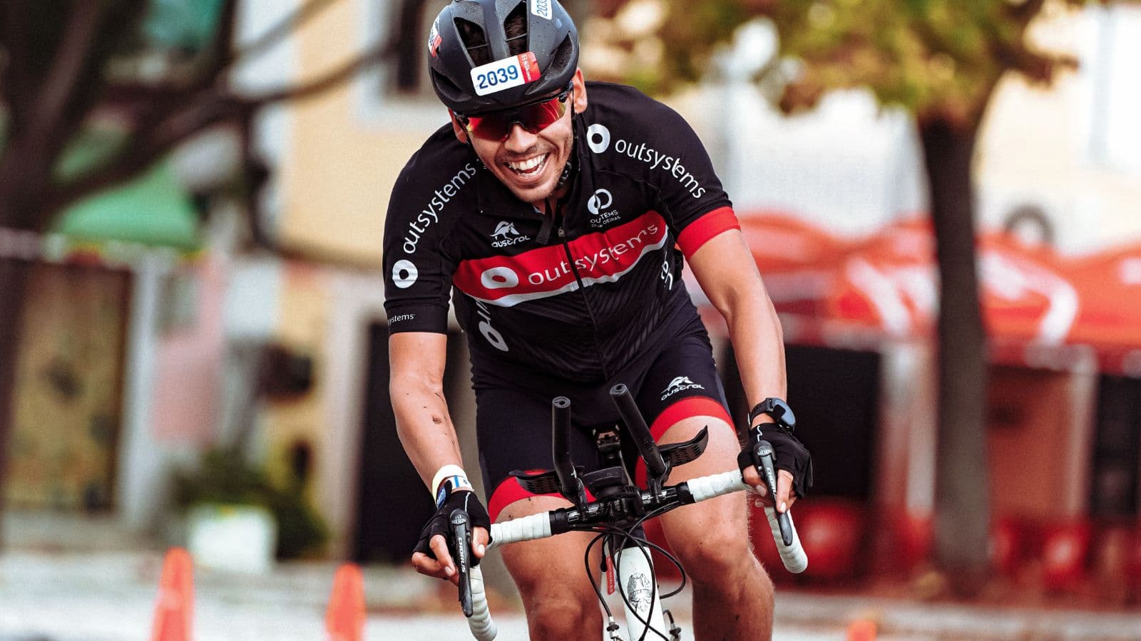 Triathlete riding a road bike with an efficient, smooth pedal stroke to improve cycling performance and power transfer.