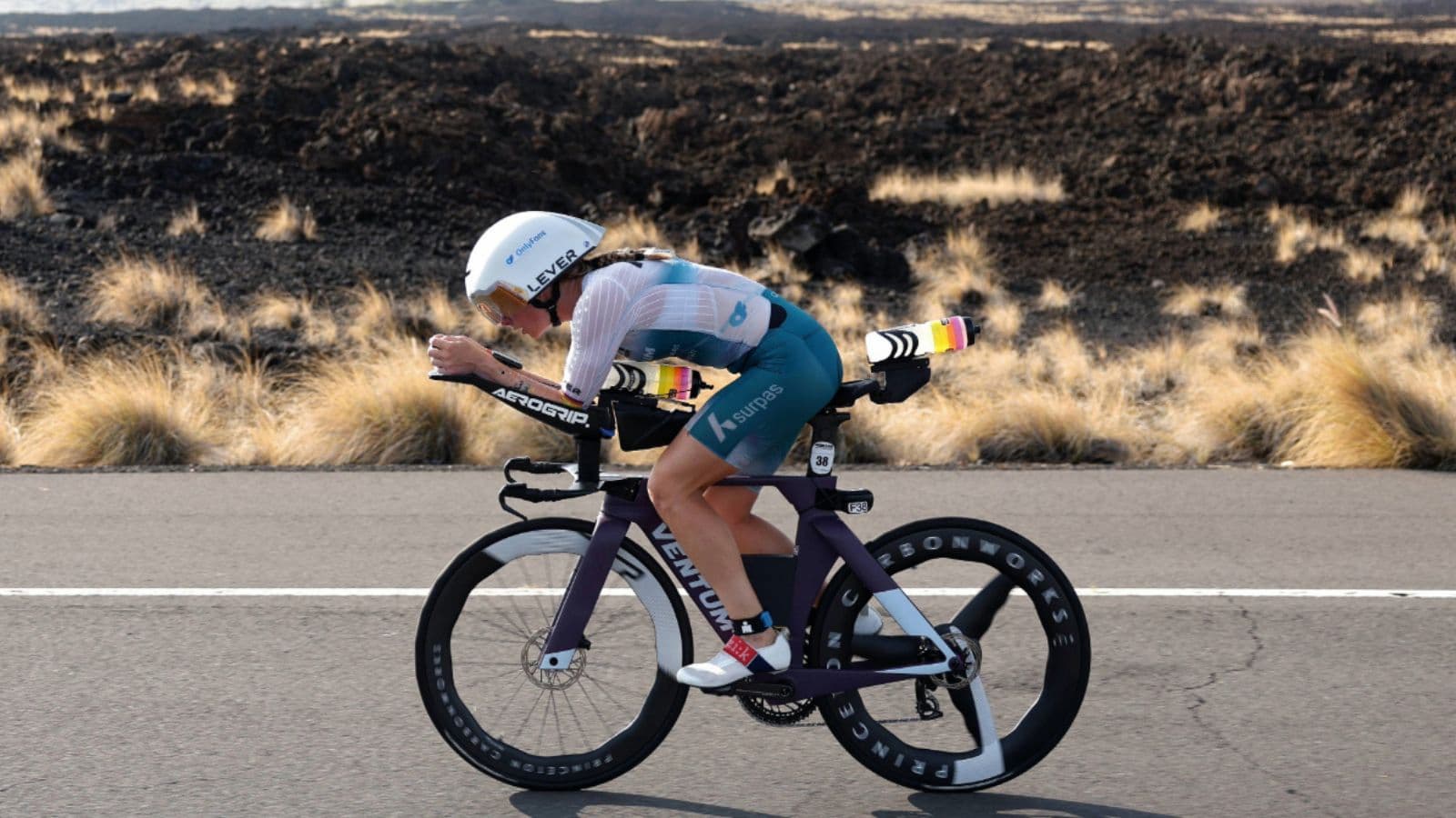 Triathlete completing a steady endurance ride on a road bike to build aerobic fitness for triathlon cycling.