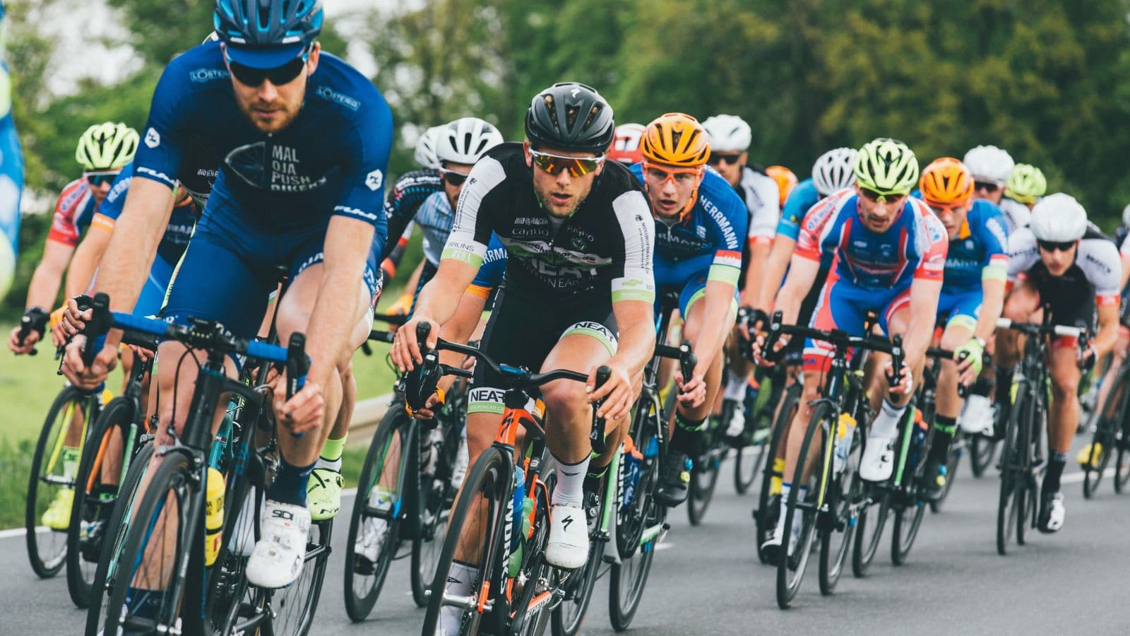 triathlete riding in group cycling session to improve bike handling skills and cycling performance