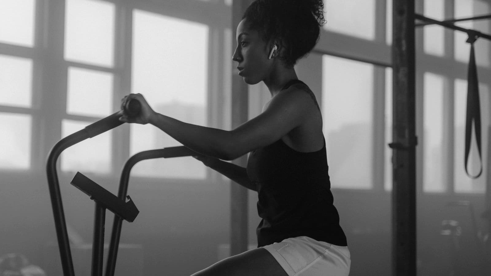 triathlete riding indoor smart trainer during structured cycling workout to stay motivated and improve fitness