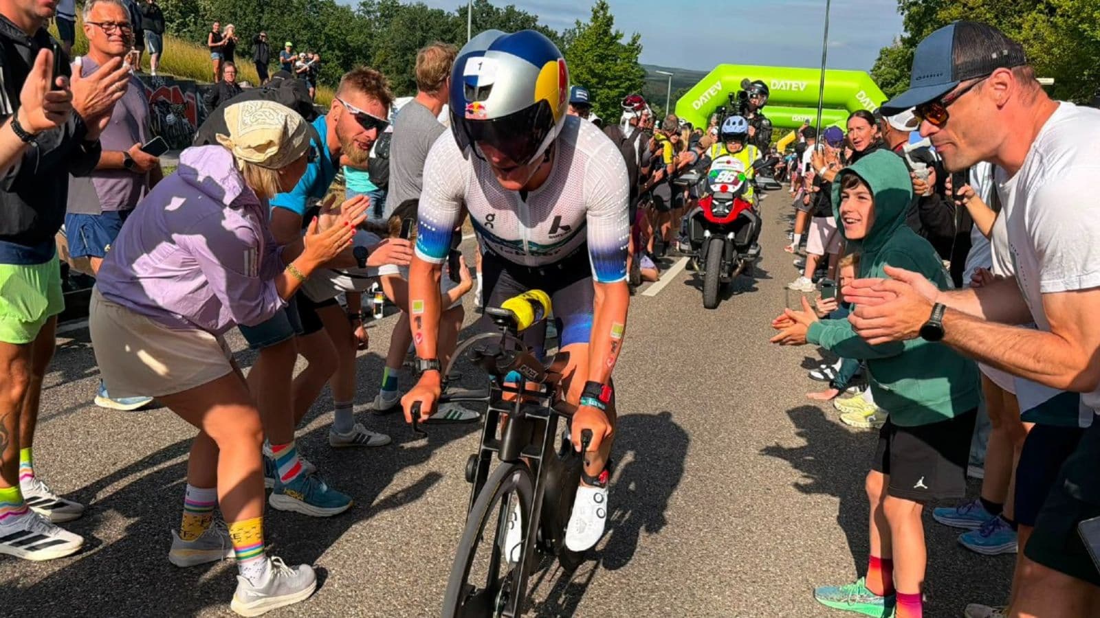 Beginner triathlete looking through an approaching corner while maintaining a balanced position on a technical cycling route.