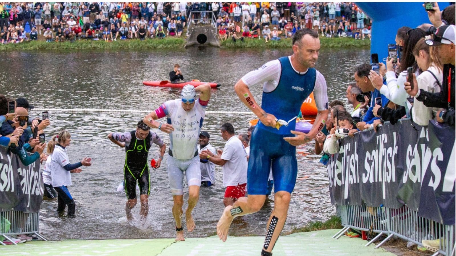 Triathlete running into the transition area after the swim to begin a fast and organized T1 during a triathlon.