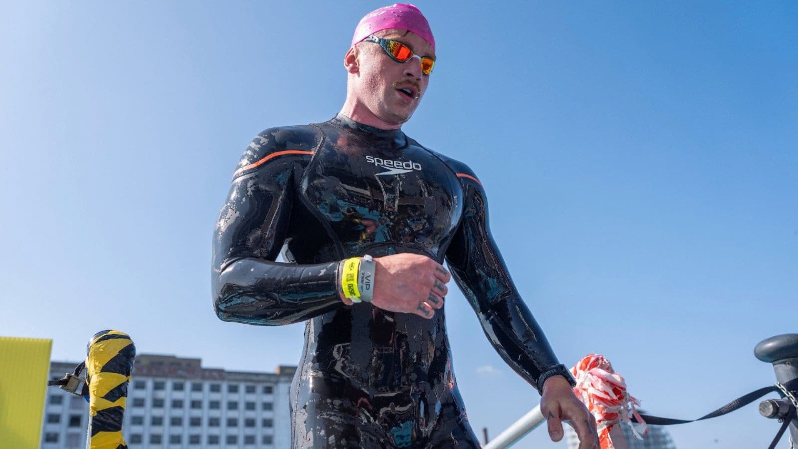 Triathlete practising relaxed freestyle technique with controlled breathing during a long swimming workout.