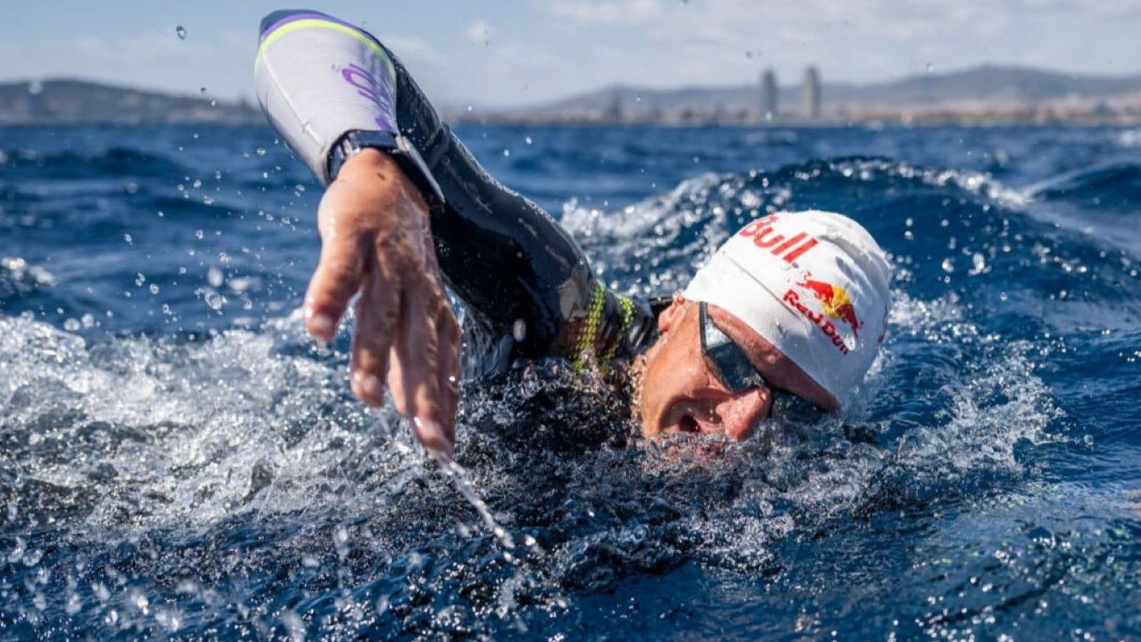 Triathlete completing a steady endurance swim in a pool to improve stamina and aerobic fitness for a triathlon.
