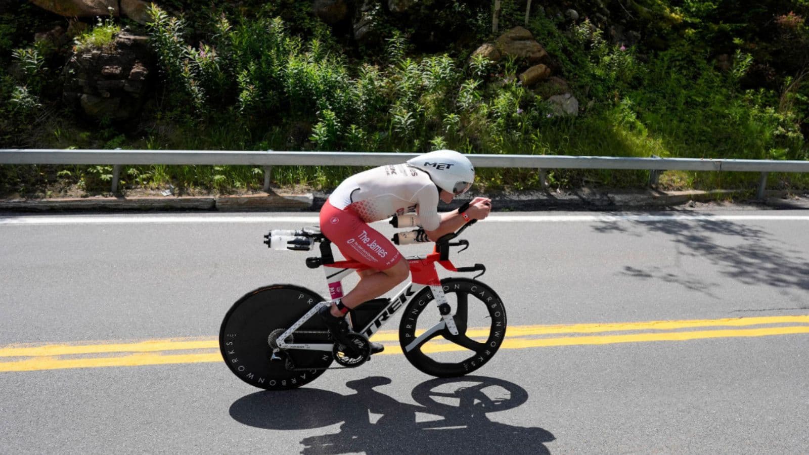 Triathlete maintaining a controlled effort on the bike to conserve energy for a stronger run during a triathlon.