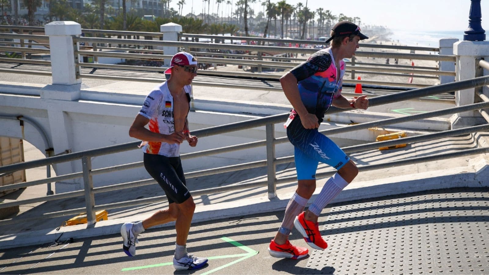 Triathlete maintaining a strong running pace near the finish after managing effort effectively throughout the triathlon run leg.