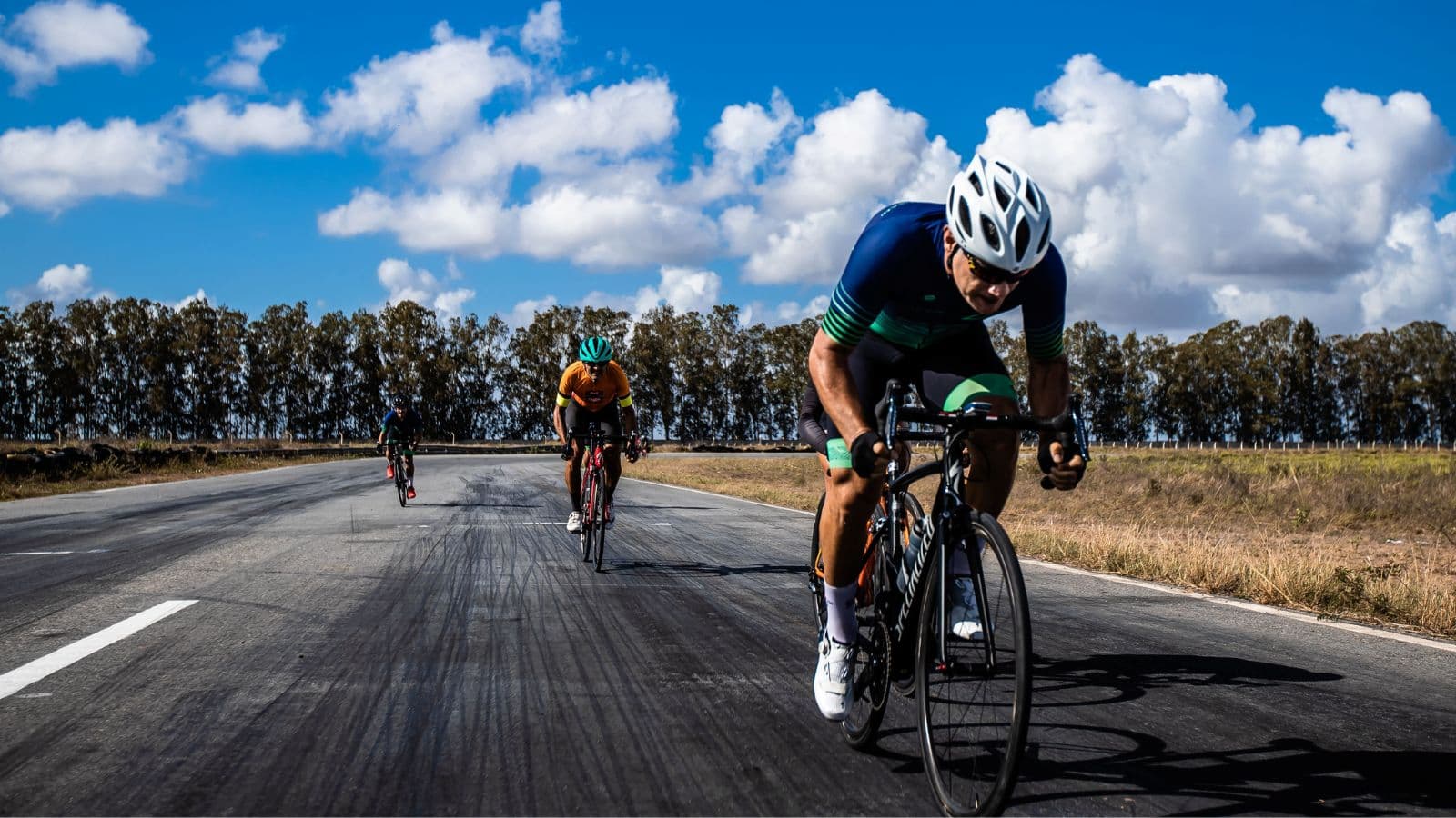 Triathlete climbing a quiet mountain road on a bike loaded with lightweight bikepacking equipment.