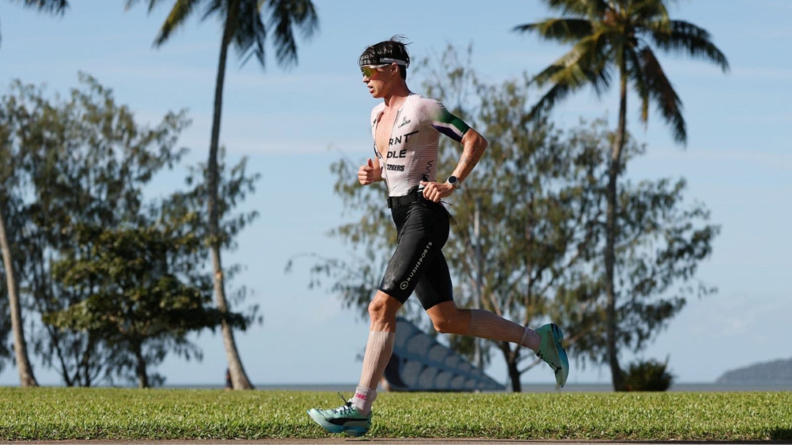 Triathlete reviewing a weekly swim, bike, and run training schedule while planning workouts around limited available time.