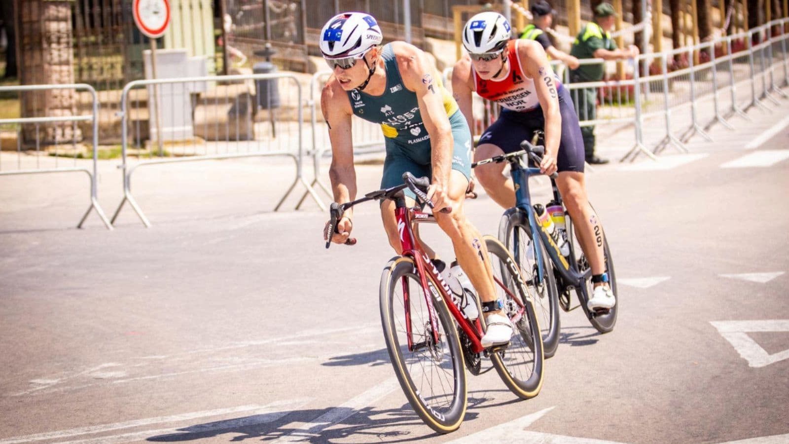 Cyclist performing a controlled bike mount while accelerating away from the start area during a cycling race.