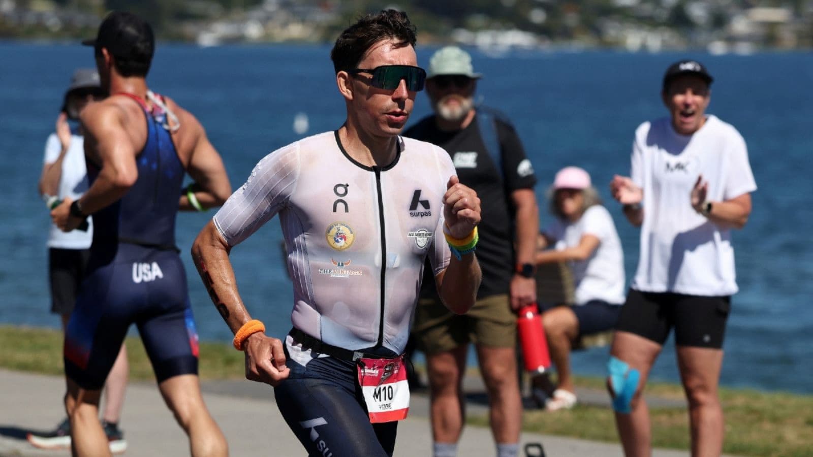 Triathlete running with controlled form after completing a well-paced cycling leg during a triathlon race.