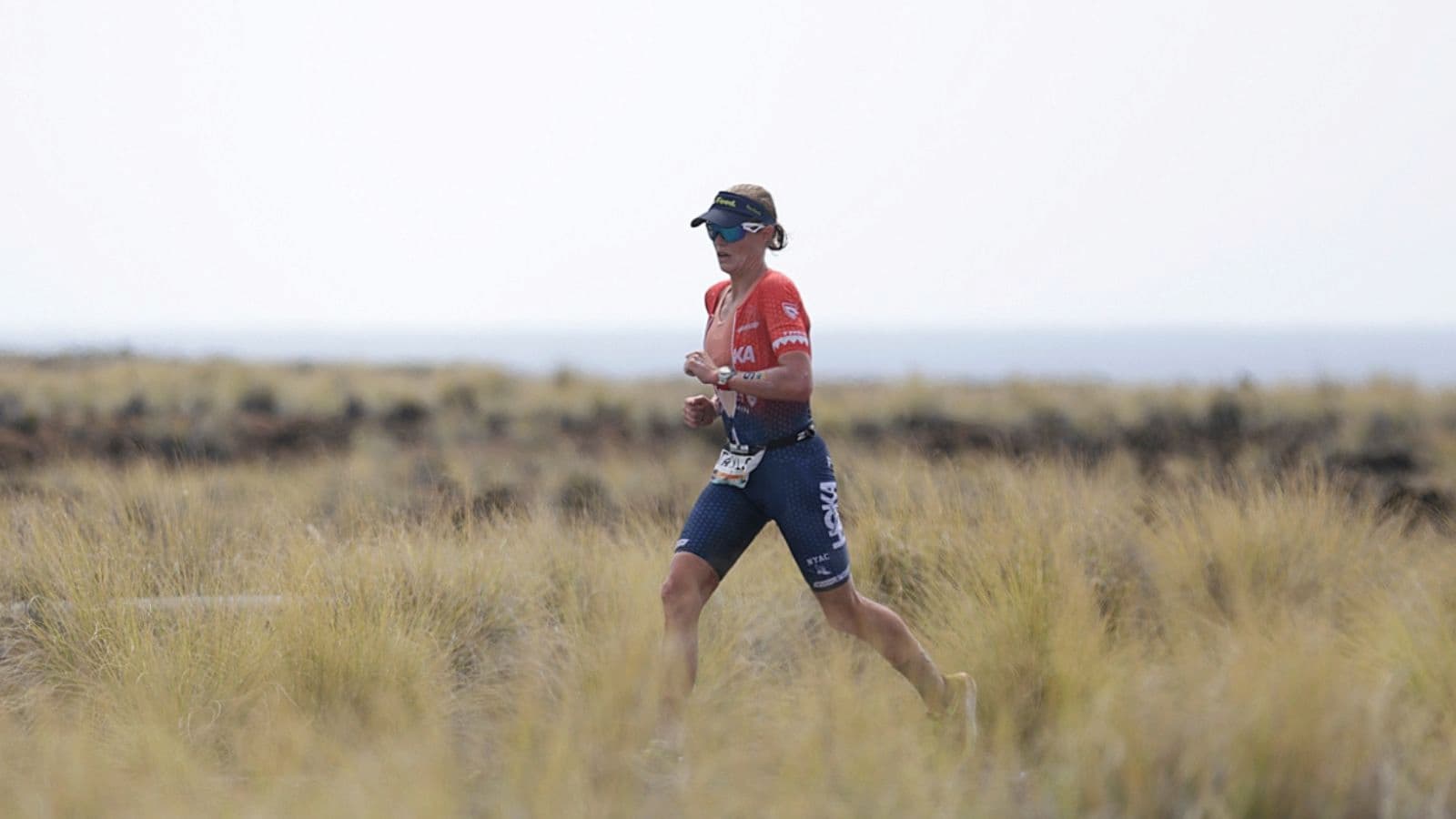 Ironman triathlete maintaining a controlled running pace during the marathon leg of a long-distance triathlon.