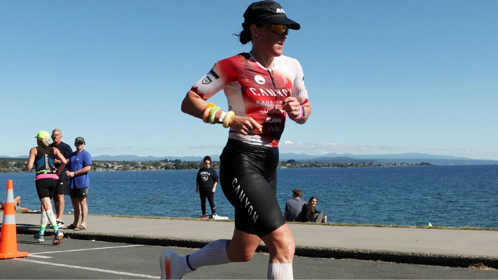 Lean triathlete starting the marathon run after transitioning from the bike during an Ironman race.