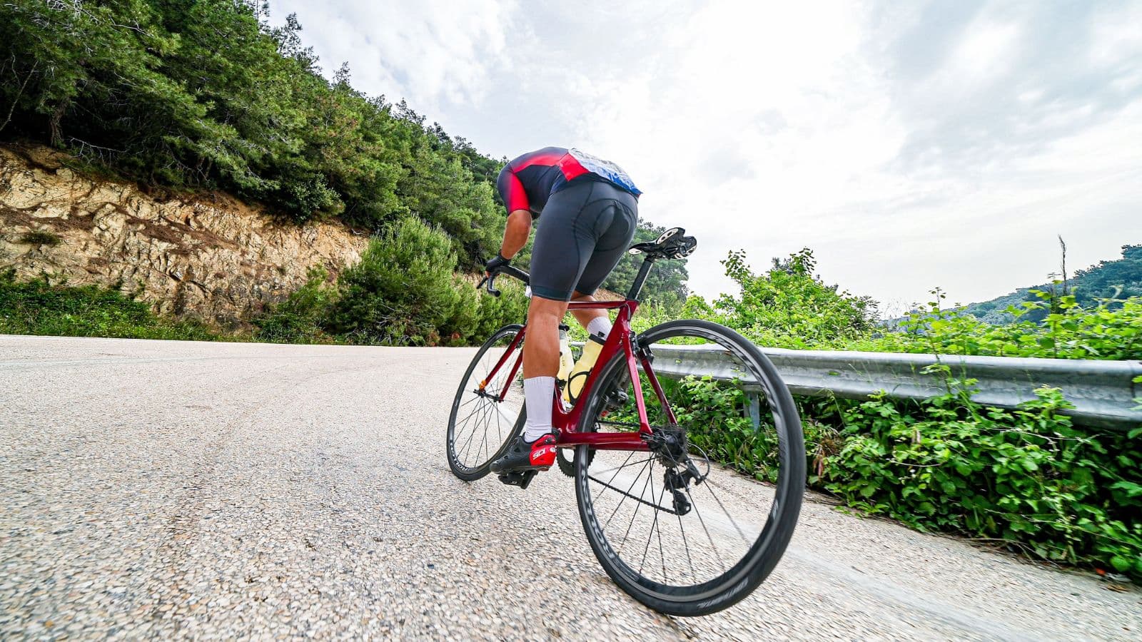 Triathlete riding for an extended period in the aero position during a long-distance triathlon bike leg.