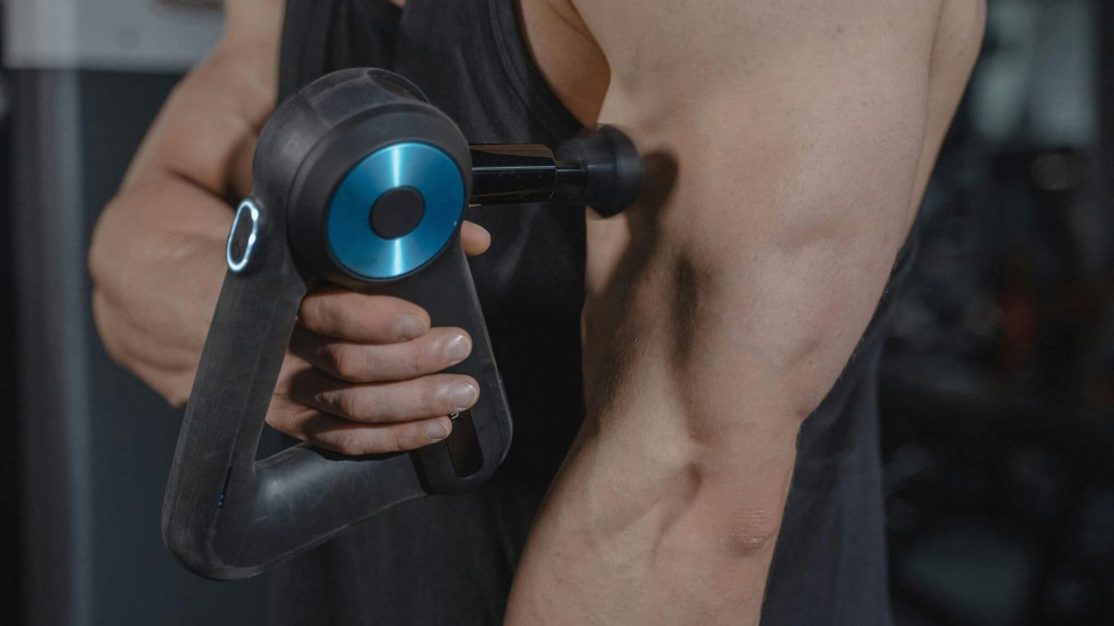 Triathlete receiving a gentle massage on the biceps muscles after a long-distance triathlon.