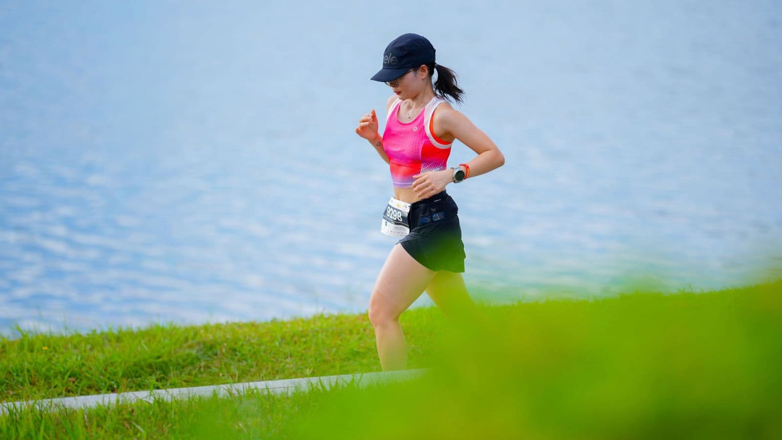 Triathlete running outdoors without headphones while staying aware of traffic, other athletes, and the surrounding environment.