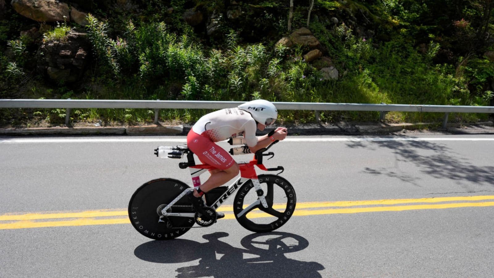 Triathlete maintaining a controlled aerodynamic pace on the bike to conserve enough energy for the run leg of a triathlon.
