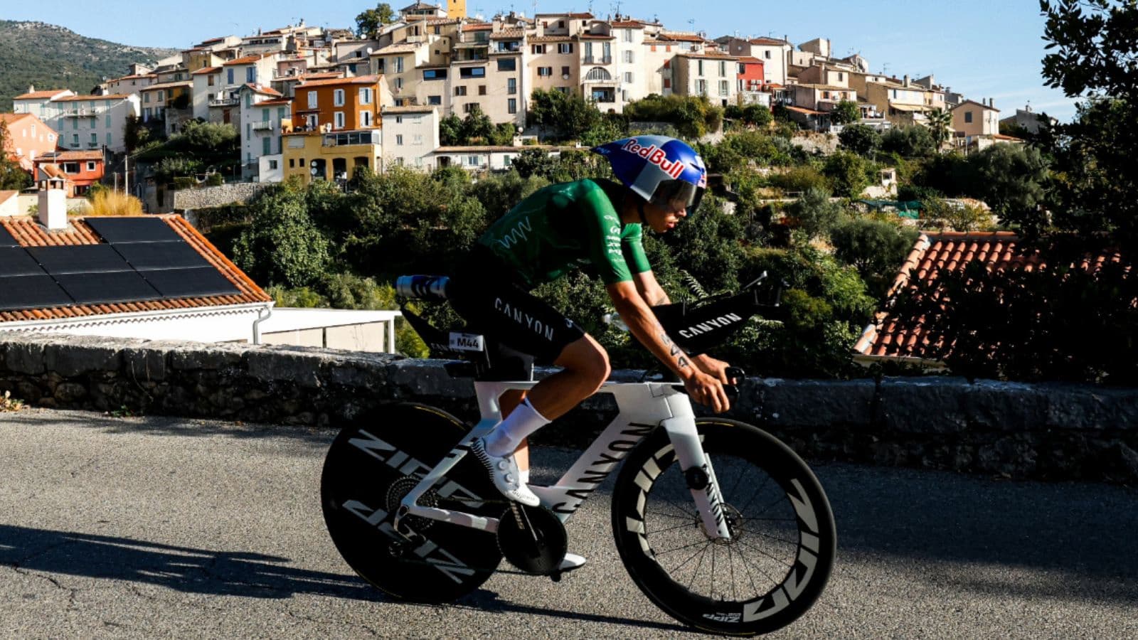 Side-by-side cyclists riding a triathlon bike and a road bike showing the differences in aerodynamic body position and bike setup.
