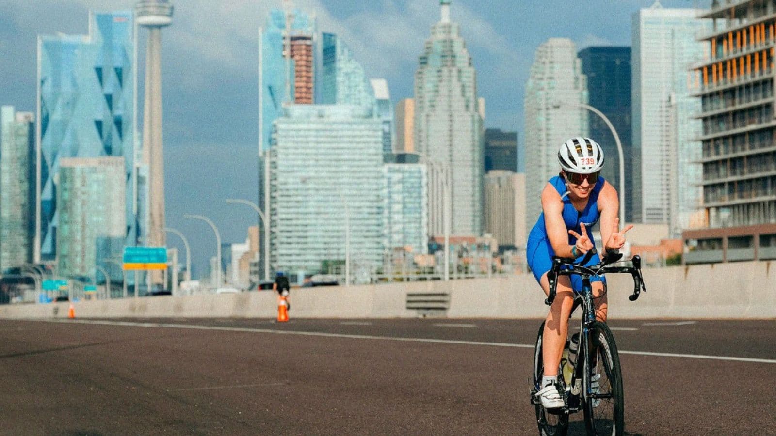 Cyclist completing short sprint intervals on a quiet road to develop power and faster cycling acceleration.