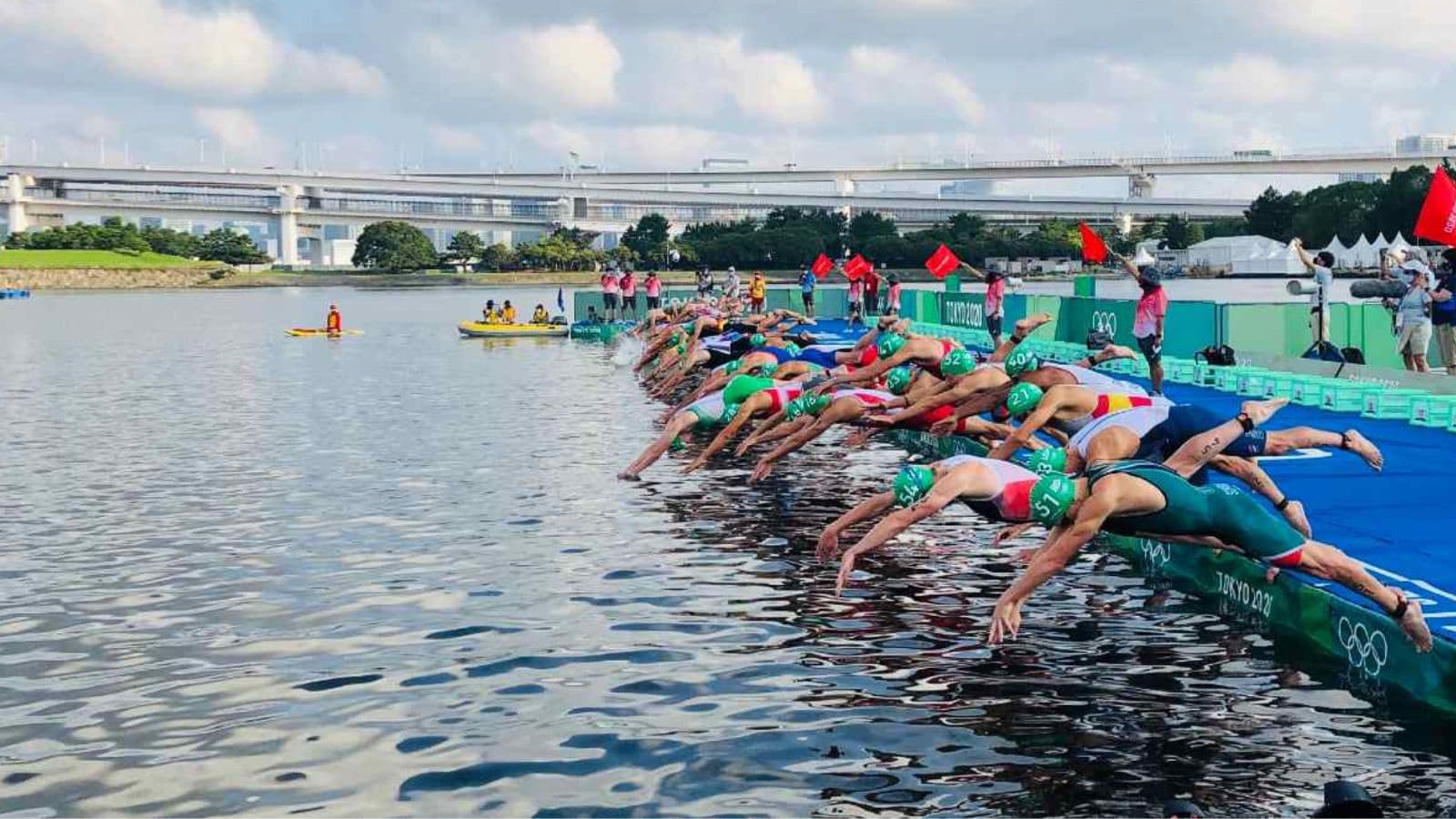 Triathlete using repeated dolphin dives to move quickly through shallow water at the beginning of an open water triathlon swim.