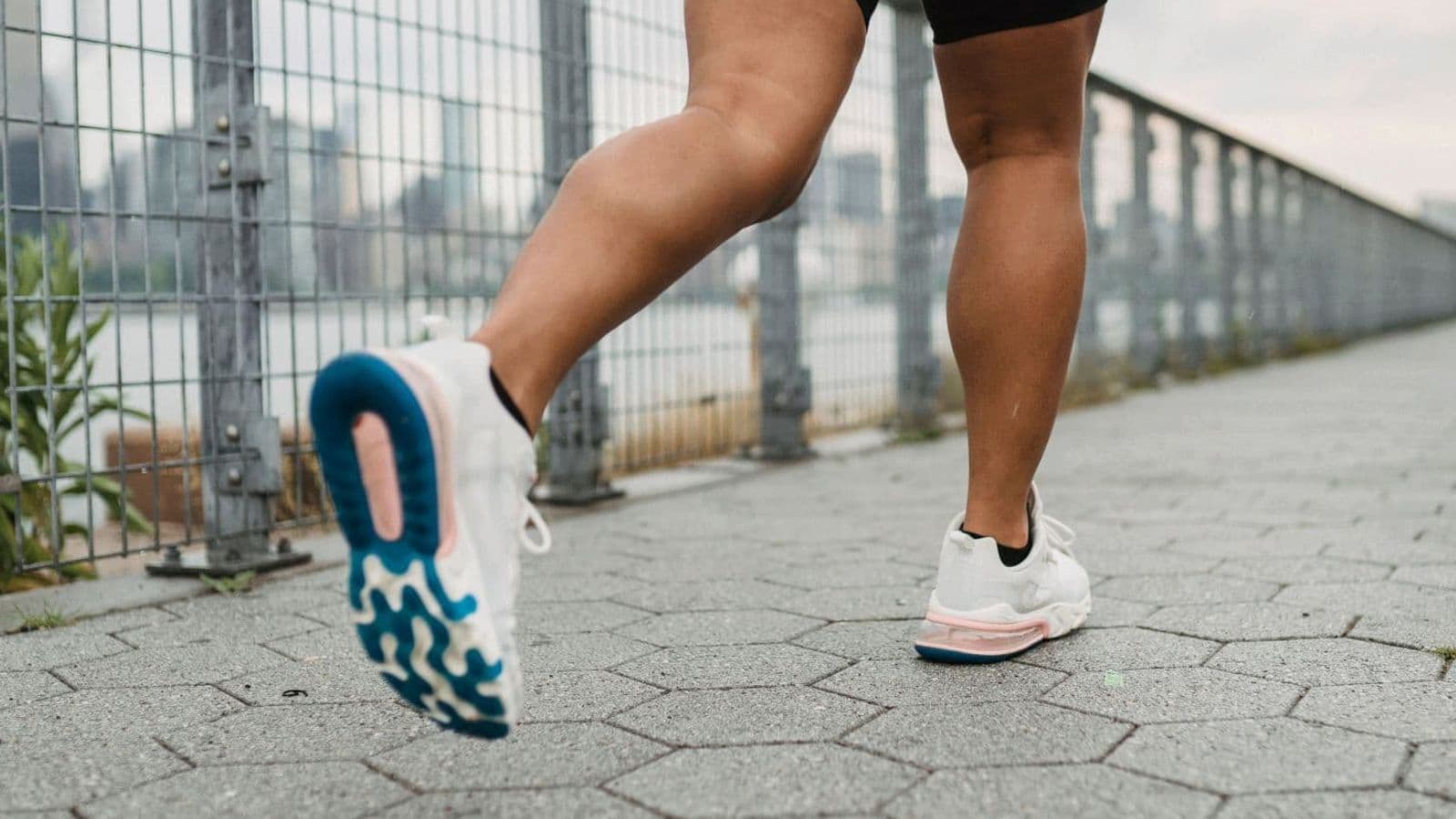 Rear view of a runner showing foot, ankle, and lower-leg movement during a natural running stride.