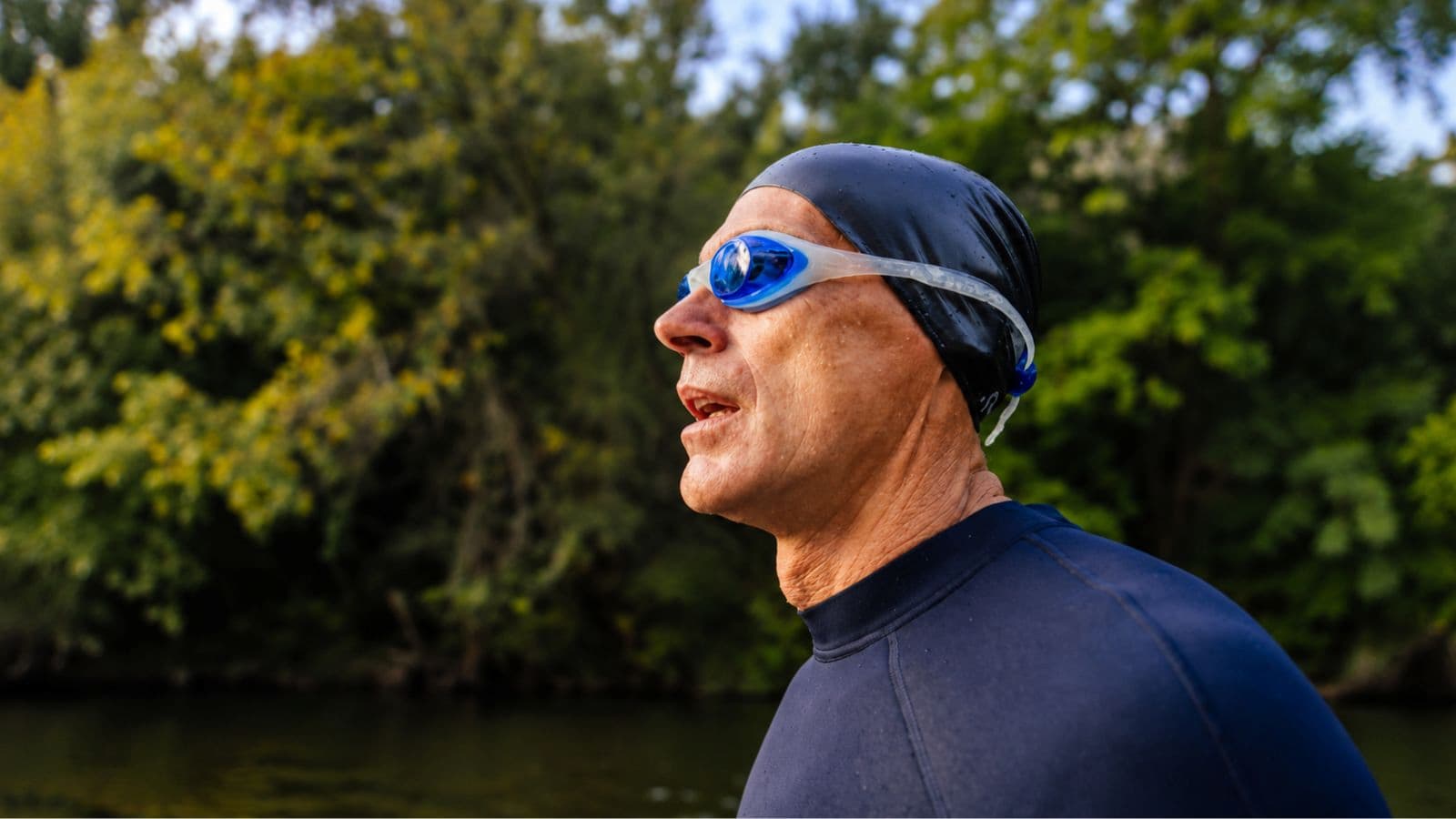 Older triathlete reviewing a structured training schedule that balances swimming, cycling, running, strength training, and recovery.