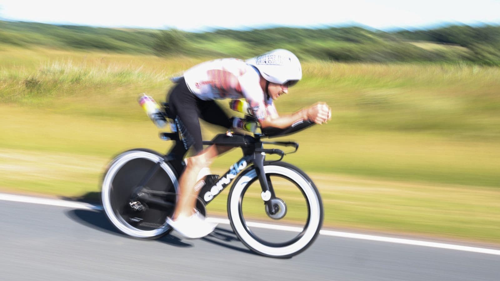 Cyclists going in high speed and constant bend down position during a triathlon