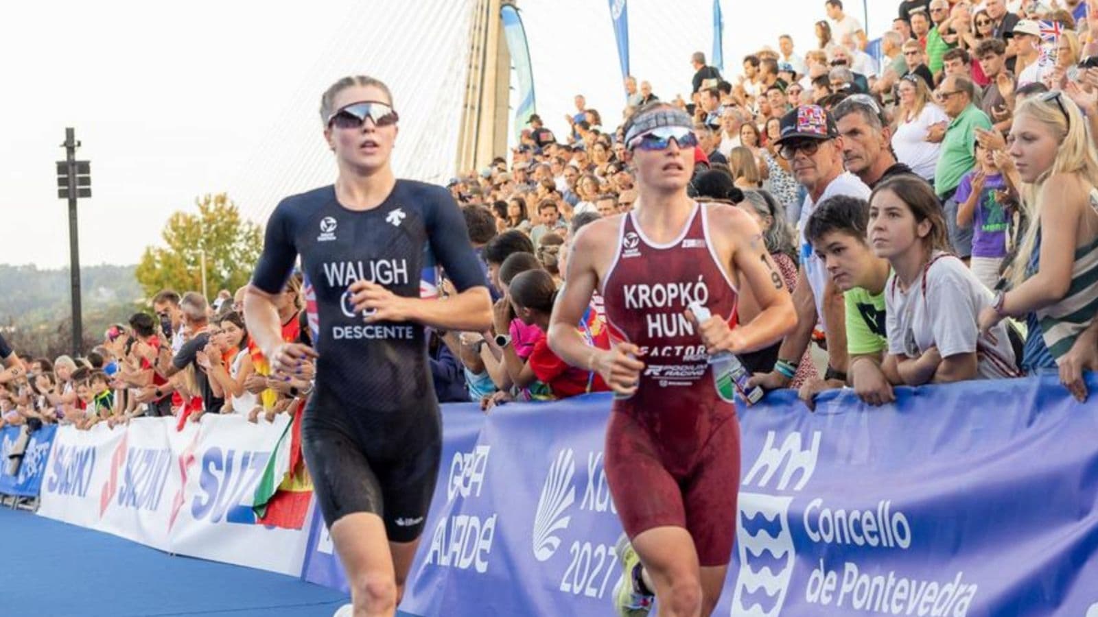 Triathlete maintaining a comfortably hard running pace during a structured tempo workout on a flat outdoor running route.