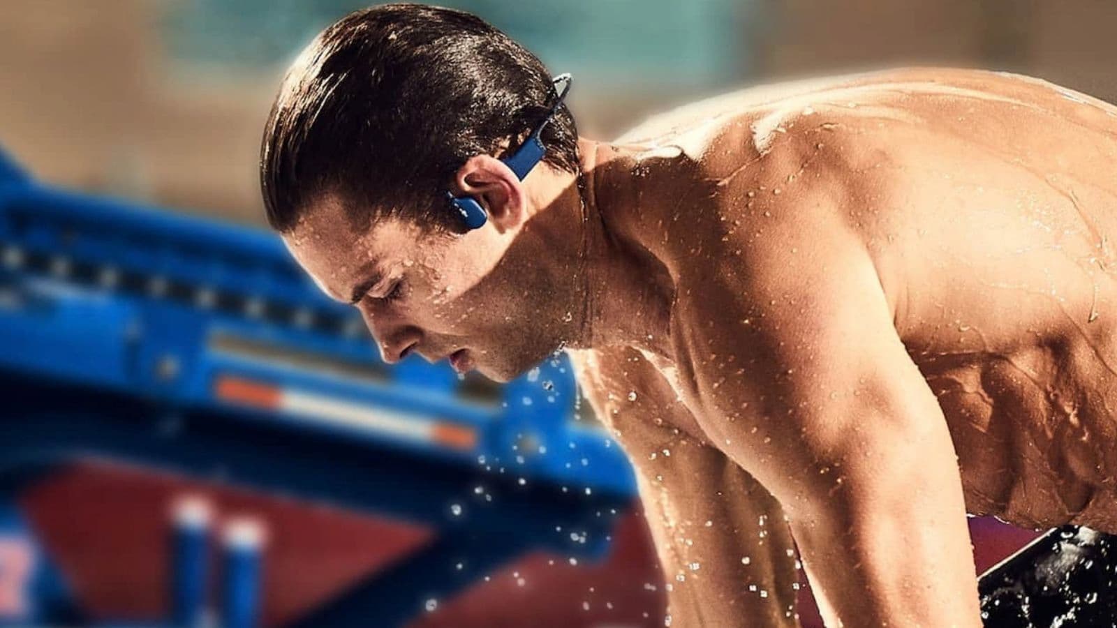 Triathlete wearing waterproof swimming earplugs while completing a pool swim to help keep water out of the ear canals.