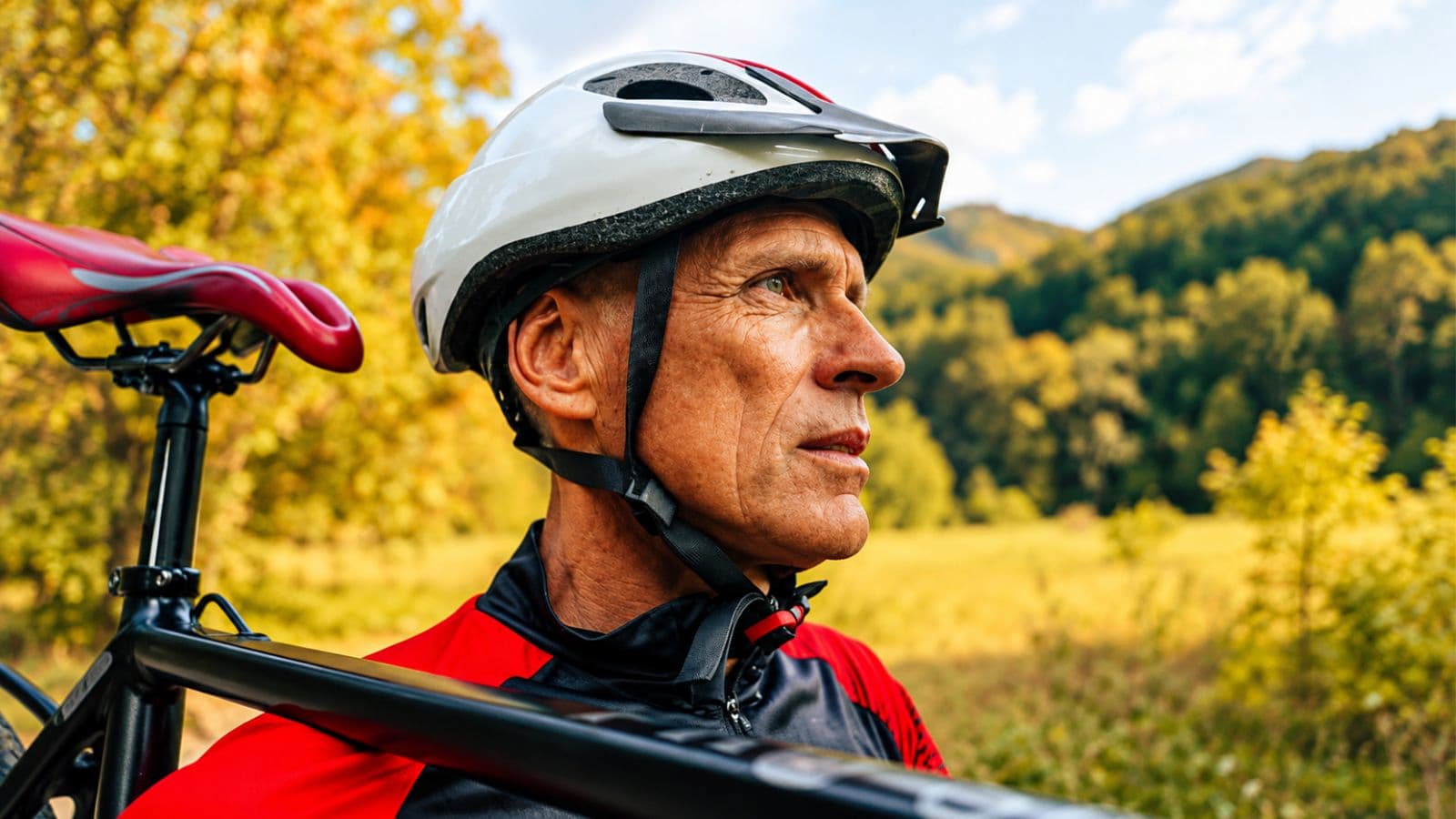 Older triathlete monitoring cycling power and heart rate while maintaining a controlled effort during the bike leg of a triathlon.