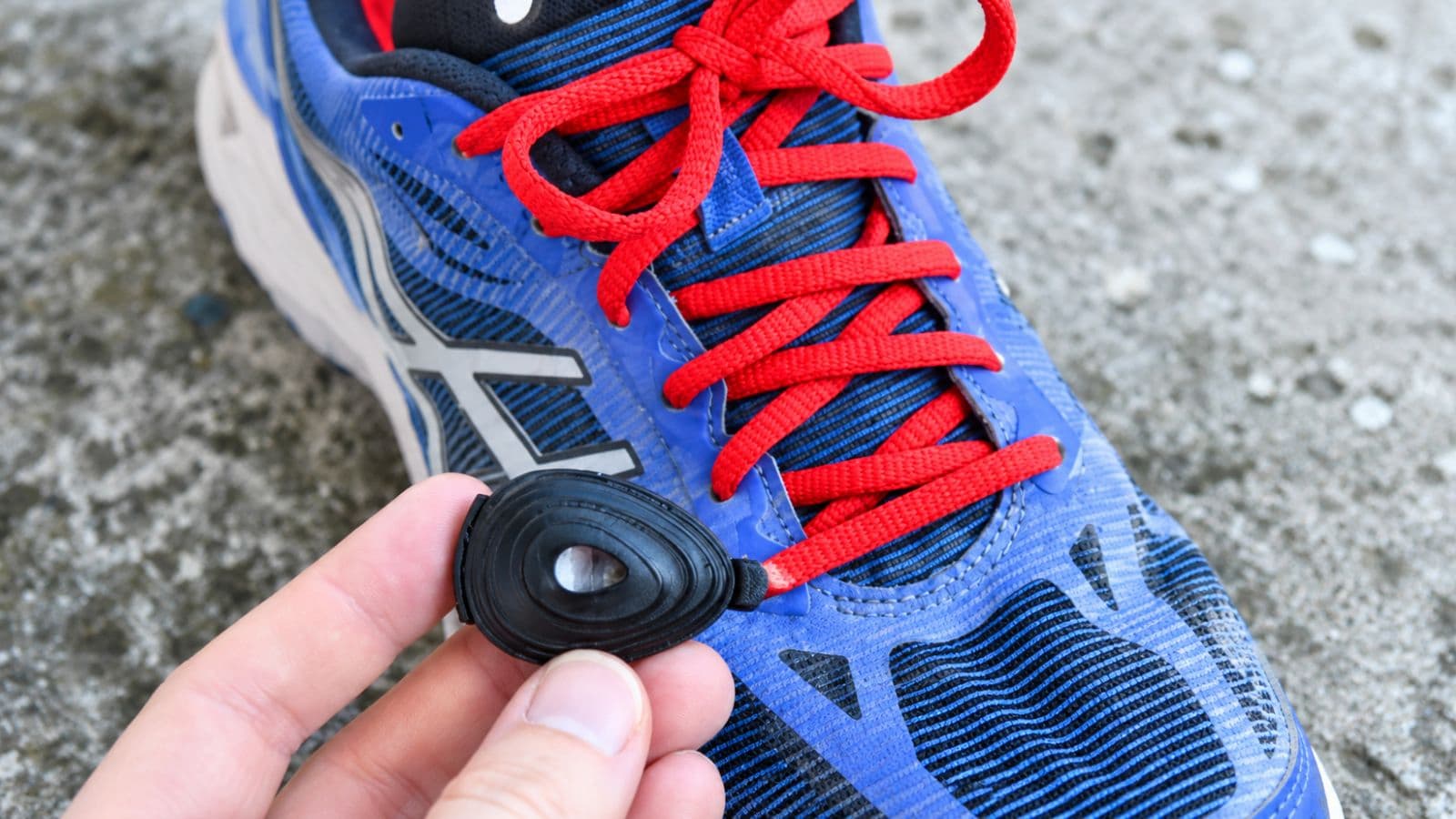 Runner checking power in watts on a sports watch while maintaining a controlled effort over rolling terrain.